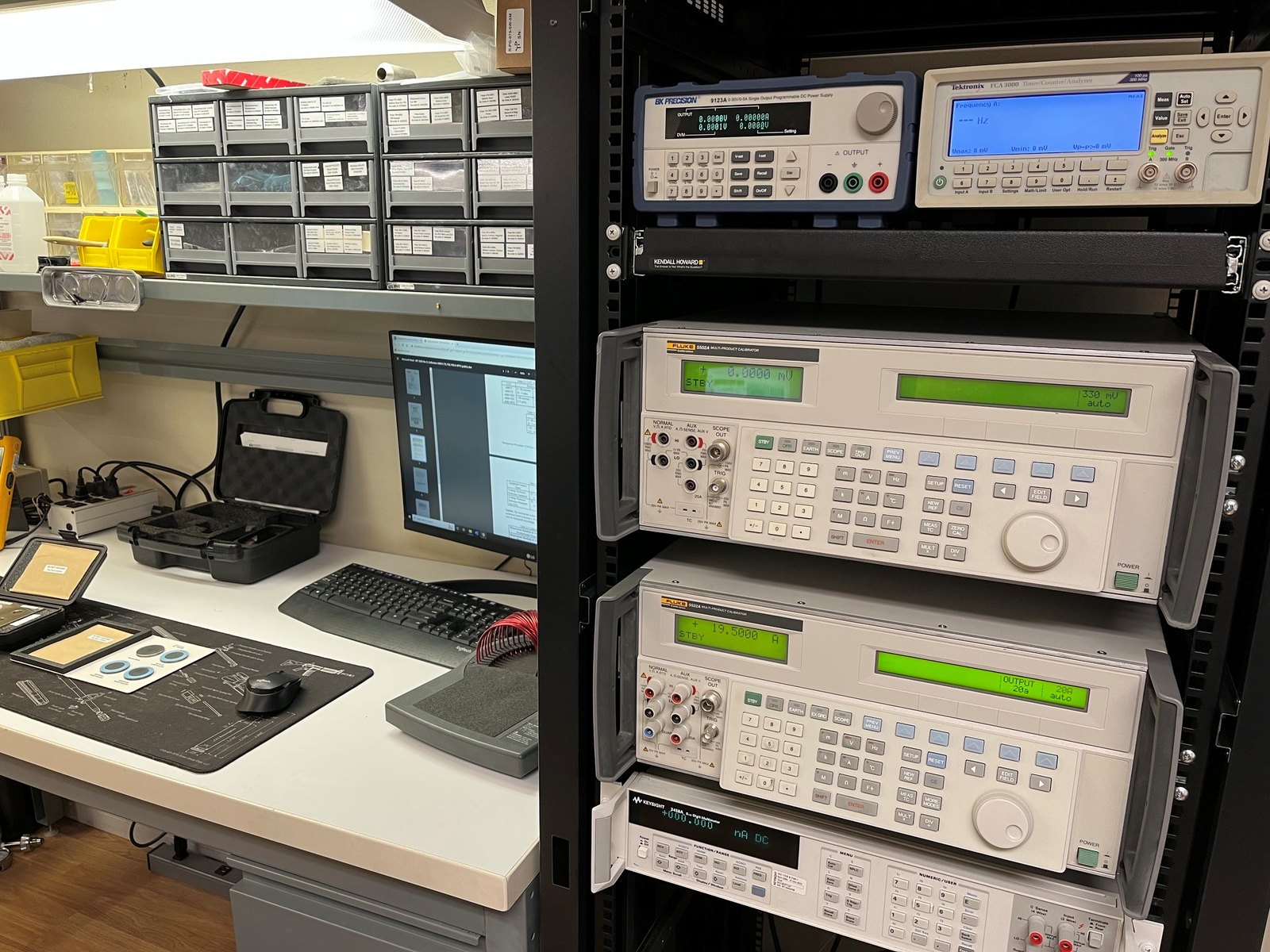 Valley Instrument electrical calibration bench with Fluke 5502A and 5522A multi-product calibrators and a Keysight 3458A reference DMM